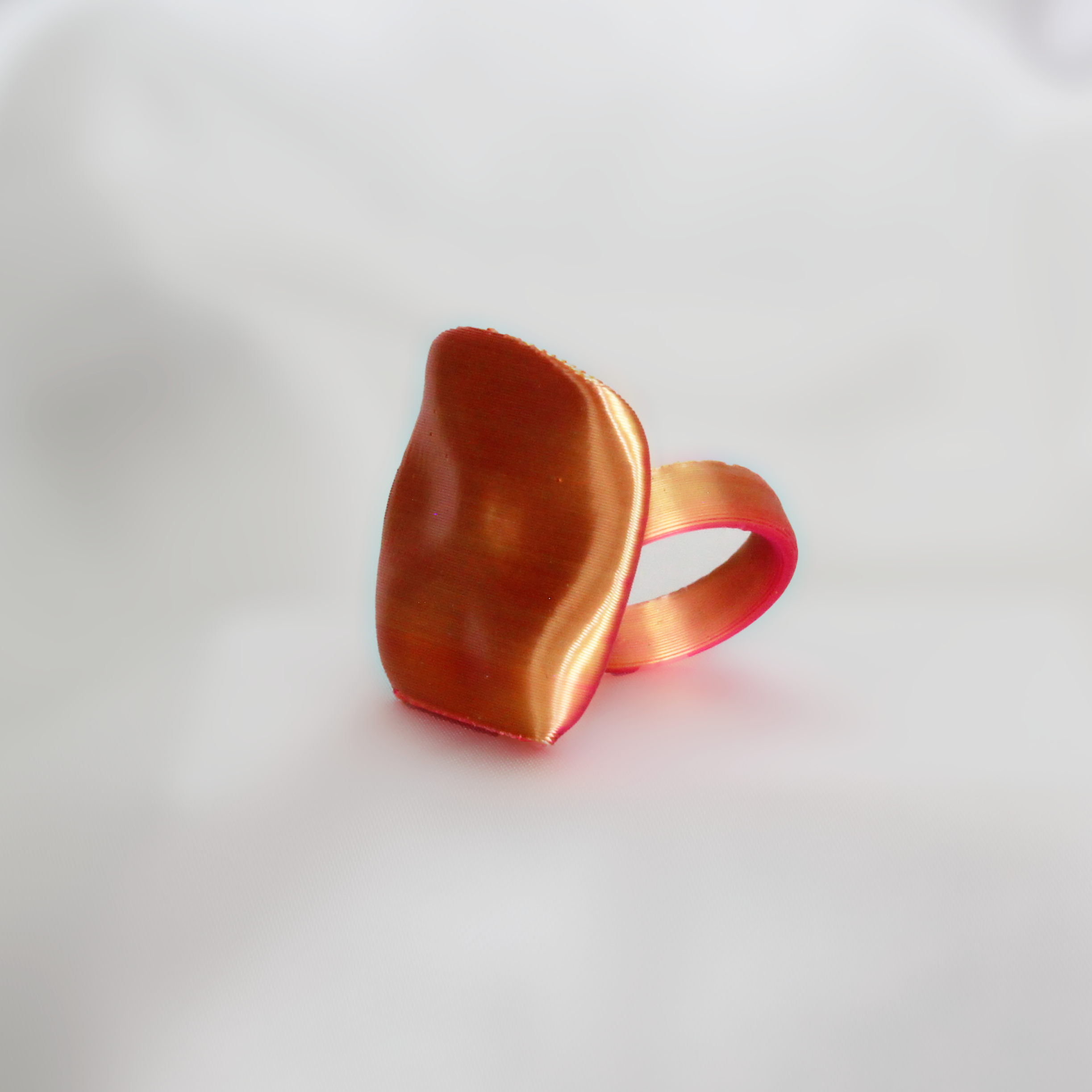 Orange ring on a white fabric background
