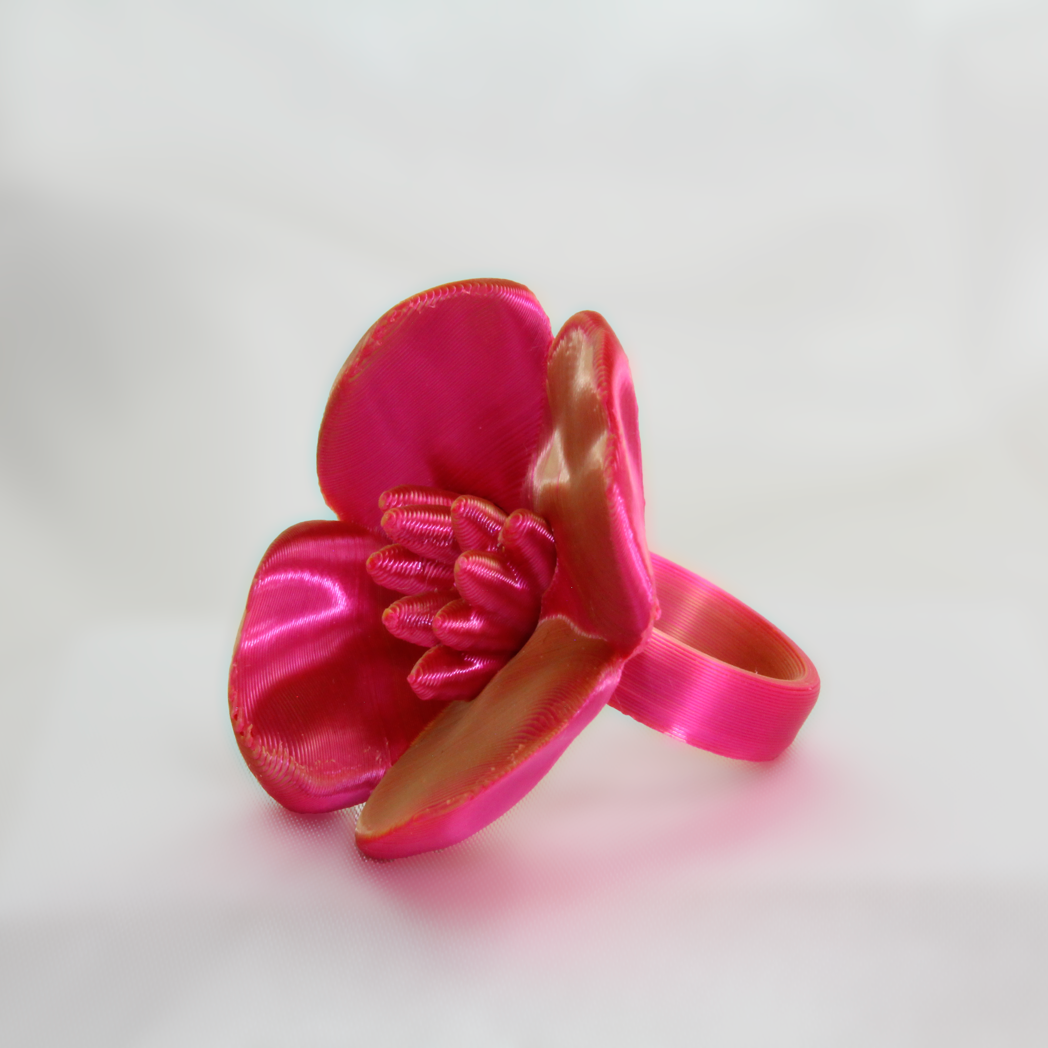 Pink flower-shaped object on a white background