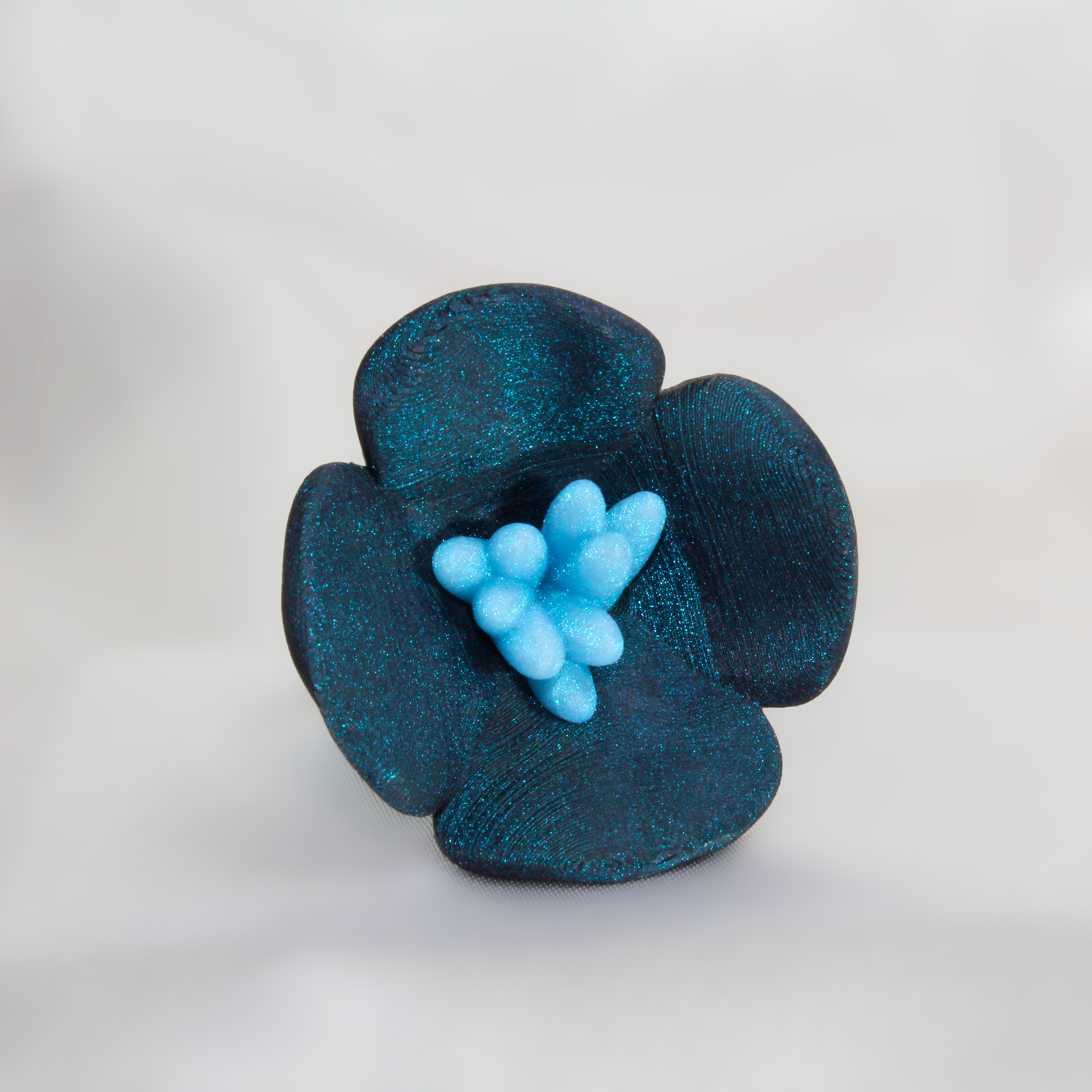 Blue flower-shaped object on a white background