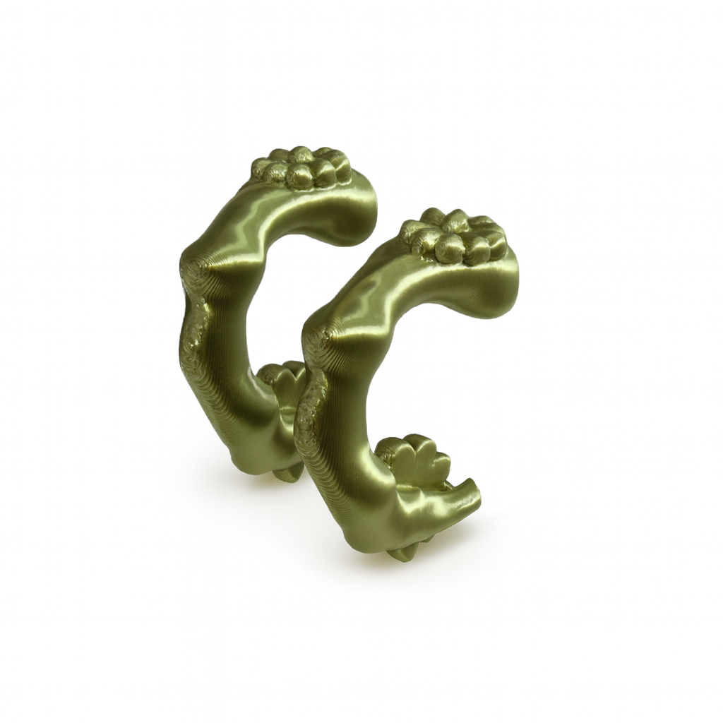Decorative green metal piece on a white background